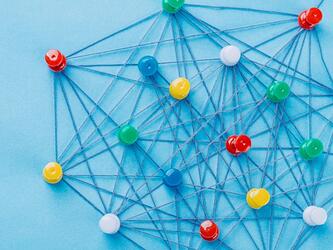 coloured pins connected by multiple lines of string